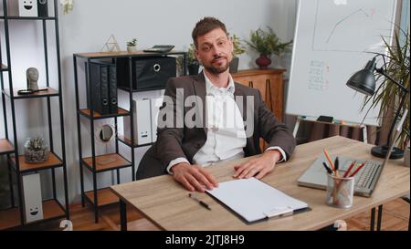 Angry furious man working at home office throwing crumpled paper, having nervous breakdown at work, migaine, headache, stress management, mental distress problems, losing temper, reaction on failure Stock Photo