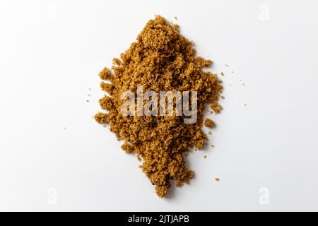 Dark brown sugar on a white background Stock Photo