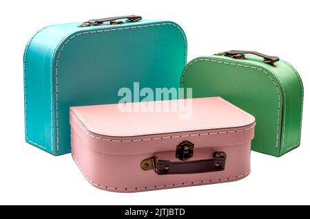 Stack of vintage cardboard suitcases in mixed vibrant colours, with each suitcase having a leather grip and secure metal lock concepts for difficult j Stock Photo
