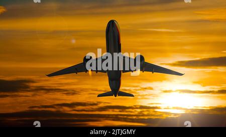 Airplane taking off with the evening sky in the background Stock Photo