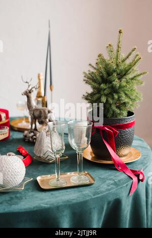 Table served for Christmas dinner in living room, close-up view, table setting, Christmas decoration. Stock Photo