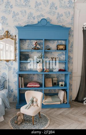 Blue wooden wardrobe in a cozy living room decorated for Christmas Stock Photo