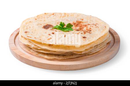 Chapati tortillas with fresh parsley are isolated in close-up on a white background. Stock Photo