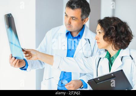 Doctor and nurse analysis x-ray image in hospital Stock Photo