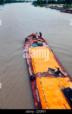 Barge and crew sailing on Thai Binh river, Hai Phong, Vietnam Stock Photo