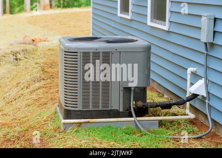 Installation of air conditioner near a new house Stock Photo