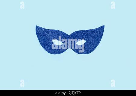 Blue party glitter eye mask on a light blue background with copy space Stock Photo