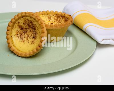 egg custard tart on a green plate with napkin Stock Photo