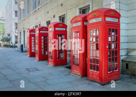 Five red phone booths in a row in Covent garden, London, UK Stock Photo