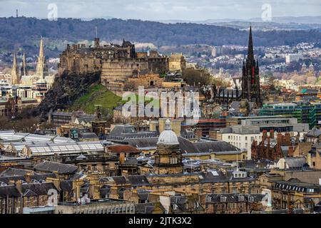 A view of Edinburgh city, castle, cathedral, and mountains from Arthur's Seat in Holyrood park. Stock Photo