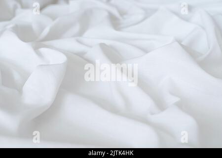 White drapery linen fabric background. Texture of the light surface of the fabric. High quality photo Stock Photo