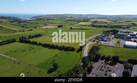 West Cork, Ireland, July 9, 2022. Clonakilty Agricultural College among fields on a sunny summer day, buildings on green grass field, top view. Stock Photo