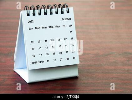 October 2022 calendar on wooden desk with customizable space for text or ideas. Copy space Stock Photo