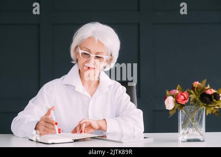senior business woman portrait day planning notes Stock Photo