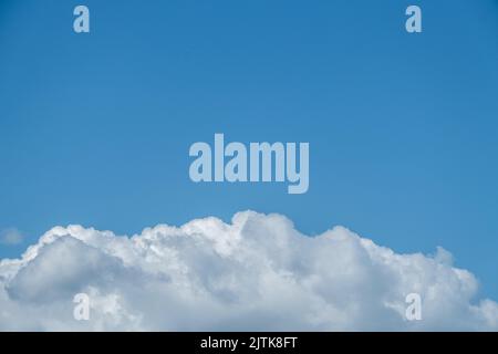 Dorking, Surrey Hills, London, UK, August 26 2022, Large White Cumulus Cloud Against A Clear Blue Sky With Copy Epace Stock Photo