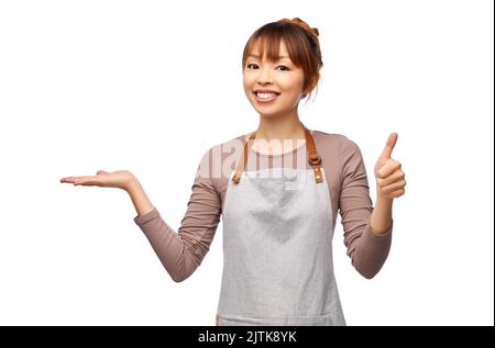 happy female chef or waitress holding something Stock Photo