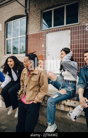 Happy multiracial young friends outside building Stock Photo