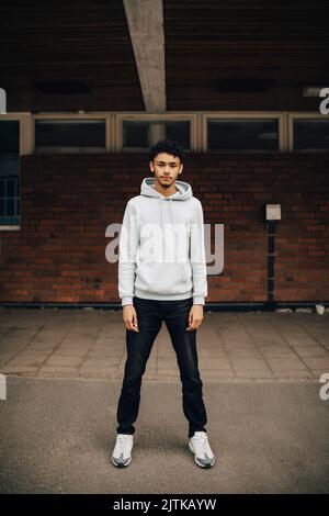 Portrait of young man standing on street Stock Photo