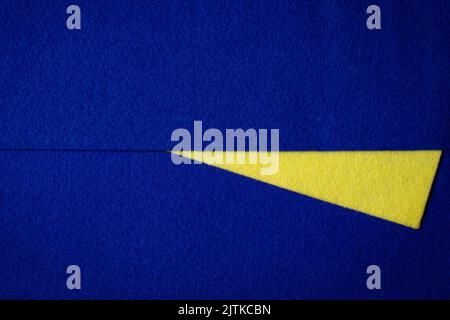 Abstract colorful geometric felt texture background. Bright yellow and navy blue colors felt textile for craft. Top view, flat lay Stock Photo