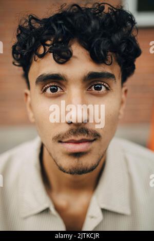 Portrait of young man with curly hair Stock Photo