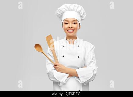 happy smiling female chef with wooden spoon Stock Photo