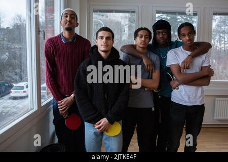 Portrait of multi-ethnic friends standing together in games room Stock Photo