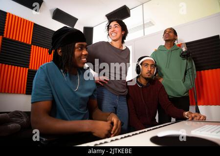 Portrait of musicians working in recording studio Stock Photo