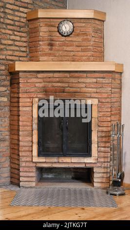 Front view of old brick fireplace with black doors isolated on white Stock Photo