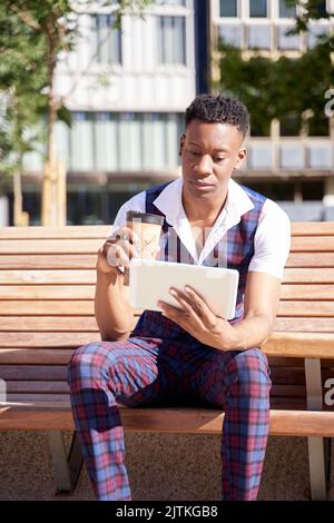 african american young man with tablet computer and take away coffee Stock Photo