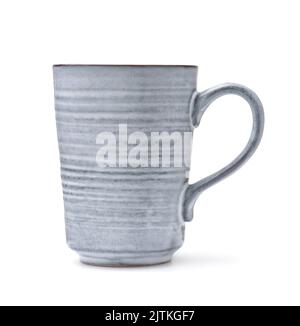 Side view of handmade rough ceramic coffee mug isolated on white Stock Photo