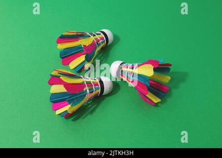 Badminton colourful shuttlecocks on green background. Stock Photo