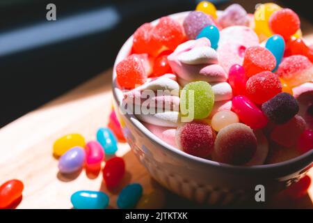 assorted candy in a white bowl in macro photography Stock Photo