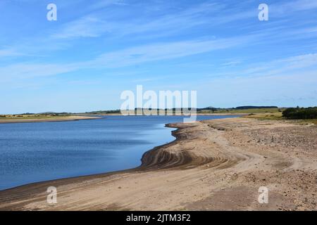 Colliford reservoir on Bodmin Moor showing dangerously low water levels. Stock Photo