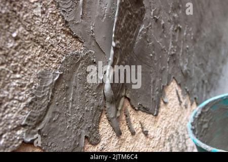 spatula passing cement on a wall in Rio de Janeiro Brazil. Stock Photo