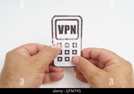 Technology and security concept. On a white background, in the hands of a person, a cardboard model of a telephone with an inscription on the screen - Stock Photo