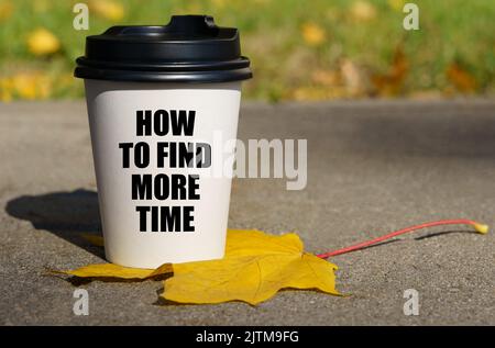 On a yellow maple leaf there is a cup of coffee on which is written - How to find more time. Business concept. Stock Photo