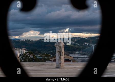 Iconic view of the Statue of King D. João III of Coimbra Portugal, viewed from inside an old steel grid. Coimbra city in Portugal. Stock Photo