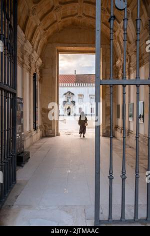 Campus of Coimbra university. Student viewed from behind on the end of a narrow corridor to the Campus University of Coimbra in Portugal. Stock Photo