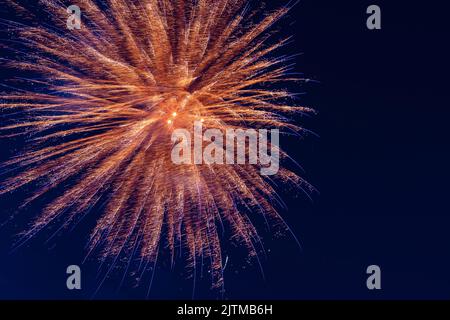 An explosion of bright single fireworks, against the background of the night sky. High quality photo Stock Photo