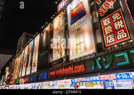 Neon signs cover the facade of the giant electronics retailer Yodobashi Camera in the shopping and entertainment district of Shinjuku, Tokyo, Japan. Stock Photo