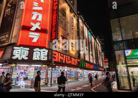 Neon signs cover the facade of the giant electronics retailer Yodobashi Camera in the shopping and entertainment district of Shinjuku, Tokyo, Japan. Stock Photo