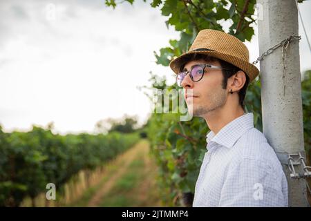Portrait of a young farmer in his vineyard looking forward, confident gaze on the future Stock Photo