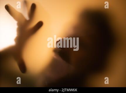 scary picture of hands behind glass, horror ghost behind door, Halloween  concept Stock Photo