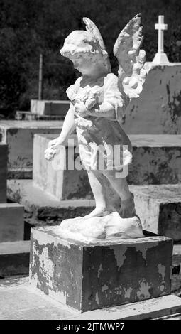 Grayscale vertical shot of an old statue in Montjuic Cemetery ...