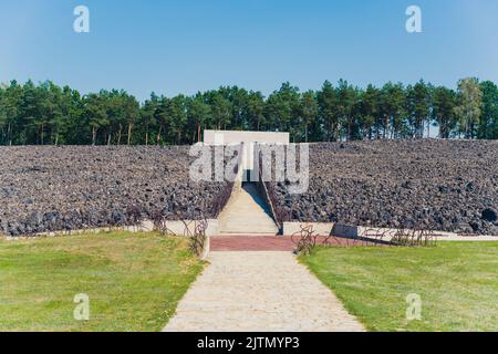 08.27.2022 - Belzec, Poland - Belzec Nazi Death Camp. Entrance to nazi death camp memorial museum. Stone remains concrete walls and path. Holocaust. Horizontal shot. High quality photo Stock Photo