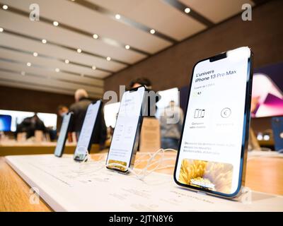 Paris, France - Nov 3, 2021: Hero object shot of new latest Apple Computers iphone smartphone 13 pro - defocused customers in background Stock Photo