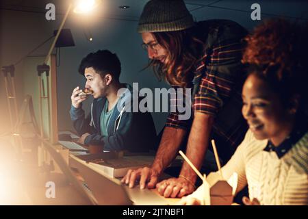 Working late without the fuss. young employees working late into the evening. Stock Photo