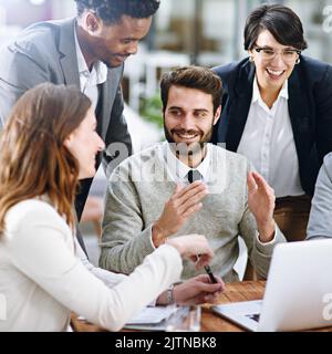 Its all about grabbing hold of good opportunities. a group of businesspeople working together on a laptop in an office. Stock Photo