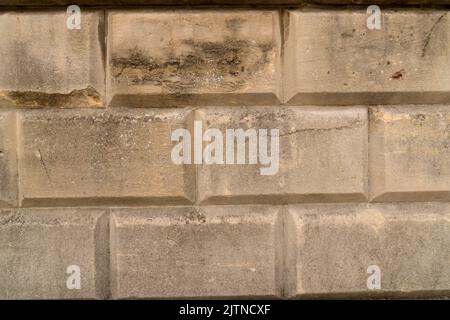 Close up beige old historical structured bricked wall facade for use as background with rectangular shaped sandstones Stock Photo