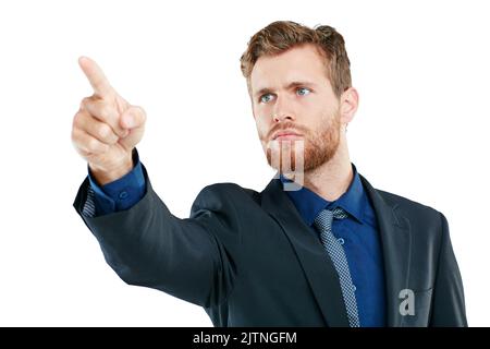 What could this be all about. Studio shot of a handsome young businessman pointing at copyspace against a white background. Stock Photo